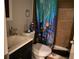 Small bathroom showcasing colorful shower curtain, toilet and vanity sink at 6802 Potomac, Fairburn, GA 30213