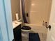 Bathroom showcasing a sink with a dark vanity, toilet, and shower with blue accents at 6802 Potomac, Fairburn, GA 30213