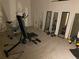 Home gym equipment including a stationary bike, weight bench, and mirrors for a complete workout space at 6802 Potomac, Fairburn, GA 30213