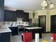 A kitchen with dark cabinets and stainless steel appliances with a center island at 6802 Potomac, Fairburn, GA 30213