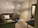 Relaxing living room with a comfortable olive green sofa and modern light fixture creates a cozy atmosphere at 6802 Potomac, Fairburn, GA 30213