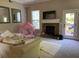 Living room features a stone fireplace and access to outdoor deck at 6802 Potomac, Fairburn, GA 30213