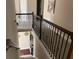 Staircase with dark wood railings and carpeted steps at 6802 Potomac, Fairburn, GA 30213