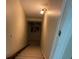 Carpeted stairway leads downward with a wall lamp illuminating the path and artwork enhancing the space at 6802 Potomac, Fairburn, GA 30213