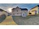 Spacious backyard featuring a lush lawn, a charming two-story home, and a patio at 6808 Foxfire Pl, South Fulton, GA 30349