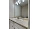 This bathroom has a sink with chrome faucet, cabinets and a mirror with vanity lighting at 6808 Foxfire Pl, South Fulton, GA 30349