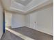 Bedroom with carpet flooring, large window, tray ceilings, natural light and two doors at 6808 Foxfire Pl, South Fulton, GA 30349