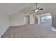 Bonus room showcasing carpet flooring, vaulted ceilings with fan and windows at 6808 Foxfire Pl, South Fulton, GA 30349