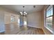 Bright dining area with wood floors and a view of the living room at 6808 Foxfire Pl, South Fulton, GA 30349