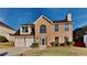 Charming two-story brick home with a two-car garage and manicured front yard at 6808 Foxfire Pl, South Fulton, GA 30349