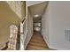 Bright hallway with hardwood floors, leading to a kitchen with white cabinets at 6808 Foxfire Pl, South Fulton, GA 30349