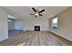 Inviting living room with hardwood floors, a fireplace, and modern ceiling fan at 6808 Foxfire Pl, South Fulton, GA 30349