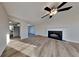 Spacious living room with hardwood floors, fireplace, and ceiling fan at 6808 Foxfire Pl, South Fulton, GA 30349