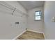 A walk-in closet with built in shelving, utility connections and hardwood floors at 6808 Foxfire Pl, South Fulton, GA 30349