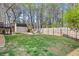 Spacious fenced backyard with shed, fire pit, and deck overlooking a large grassy area perfect for outdoor activities at 2876 Davis Mill N Rd, Dallas, GA 30157