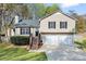Charming split-level home features a well-manicured lawn, two-car garage, and inviting front porch at 2876 Davis Mill N Rd, Dallas, GA 30157