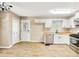 Well-lit kitchen featuring stainless steel appliances, white cabinetry and wood-look flooring at 2876 Davis Mill N Rd, Dallas, GA 30157