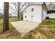 An open concrete patio area adjacent to a white brick house, perfect for outdoor entertaining and relaxation at 3888 W Oak Dr, Douglasville, GA 30135