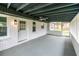 An enclosed back porch with white brick walls, painted floor, and screened openings offering natural light at 3888 W Oak Dr, Douglasville, GA 30135