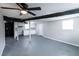 Finished basement featuring light gray walls, a black ceiling fan, and a kitchenette area at 3888 W Oak Dr, Douglasville, GA 30135