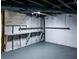 A utilitarian basement with exposed ceiling, storage shelves and a grey painted concrete floor at 3888 W Oak Dr, Douglasville, GA 30135
