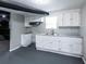 The basement kitchen offers white cabinets, grey countertops, and a stainless steel double sink at 3888 W Oak Dr, Douglasville, GA 30135
