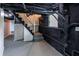 Basement stairs with painted steps, walls, and exposed pipes for a utilitarian, minimalist design at 3888 W Oak Dr, Douglasville, GA 30135