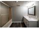 Bathroom with a shower/tub combo and a vanity with a white countertop and dark wood flooring at 3888 W Oak Dr, Douglasville, GA 30135