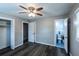 Bedroom with wood-look floors, a ceiling fan, two windows, closet and an ensuite bathroom at 3888 W Oak Dr, Douglasville, GA 30135