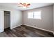 Cozy bedroom featuring wood-look flooring, a ceiling fan, a closet, and a window for natural light at 3888 W Oak Dr, Douglasville, GA 30135