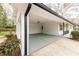 Spacious carport featuring brick walls and a painted floor, providing covered parking and potential storage at 3888 W Oak Dr, Douglasville, GA 30135
