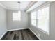 Dining area with two windows and wood-look flooring, offering ample natural light and style at 3888 W Oak Dr, Douglasville, GA 30135