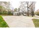 Long driveway and large carport leading to the charming, freshly painted home surrounded by mature trees at 3888 W Oak Dr, Douglasville, GA 30135