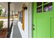 Close-up of the brightly painted green front door and shuttered windows on the porch of this charming home at 3888 W Oak Dr, Douglasville, GA 30135