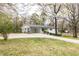 Charming single-story home with a carport and a bright green front door, situated on a well-maintained property at 3888 W Oak Dr, Douglasville, GA 30135