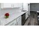 The kitchen features stainless steel appliances, granite countertops, tile backsplash, and a stainless steel sink at 3888 W Oak Dr, Douglasville, GA 30135