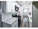 Updated kitchen featuring white cabinets, granite countertops, subway tile backsplash, and stainless steel appliances at 3888 W Oak Dr, Douglasville, GA 30135
