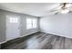 A bright living room featuring new hardwood floors, neutral paint, and a ceiling fan at 3888 W Oak Dr, Douglasville, GA 30135