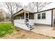 Cozy screened porch with steps leading to a patio, offering a seamless transition to outdoor enjoyment at 3888 W Oak Dr, Douglasville, GA 30135