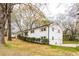 View of the side of the charming, white-brick home with freshly manicured landscaping in a lovely yard at 3888 W Oak Dr, Douglasville, GA 30135