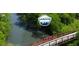 Scenic view of a pedestrian bridge crossing a calm river surrounded by dense green trees at 4385 Hickory Flat Hwy, Canton, GA 30115