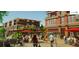 A lively city plaza bustling with pedestrians, outdoor seating, and commercial buildings in the background at 4385 Hickory Flat Hwy, Canton, GA 30115