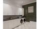 Well-organized laundry room with white cabinetry, black countertops, and modern washer and dryer at 4385 Hickory Flat Hwy, Canton, GA 30115
