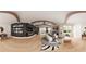 This is a spacious main bedroom with hardwood floors, a fireplace, built in shelves and stylish furnishings at 4385 Hickory Flat Hwy, Canton, GA 30115