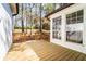 Wooden deck overlooking a fenced backyard with mature trees and landscaping at 716 Sunfield Nw Dr, Lilburn, GA 30047