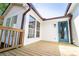 View of a wooden deck overlooking a fenced backyard with a blue door and large windows at 716 Sunfield Nw Dr, Lilburn, GA 30047
