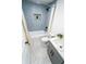 Stylish bathroom with blue tiled shower and grey vanity at 716 Sunfield Nw Dr, Lilburn, GA 30047