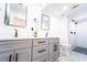 Modern bathroom featuring a double vanity, marble countertops, and a glass enclosed shower with dual shower heads at 716 Sunfield Nw Dr, Lilburn, GA 30047