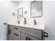 Modern bathroom featuring a double vanity with marble countertops, undermount sinks, and modern black fixtures at 716 Sunfield Nw Dr, Lilburn, GA 30047