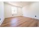 Bright bedroom with hardwood floors, white walls, and a window offering natural light at 716 Sunfield Nw Dr, Lilburn, GA 30047